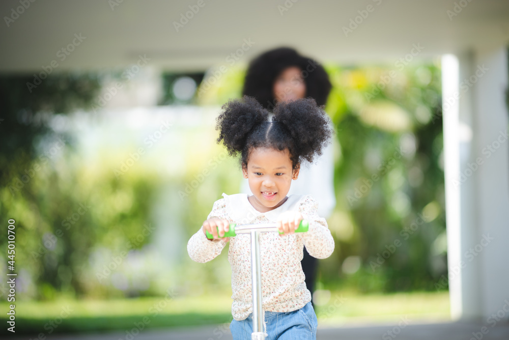 afro african kid riding on scooter, playing outdoor on a sunny day, outdoor activity concept, family concept. kid lifestyle. active sport kids. afro african kid riding on scooter, playing outdoor on a sunny day, outdoor activity concept, family concept. kid lifestyle. active sport kids.