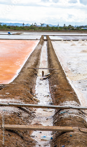 Phetchaburi Salt flats Naklua, farms and farmers collecting salt in Phetchaburi, Thailand