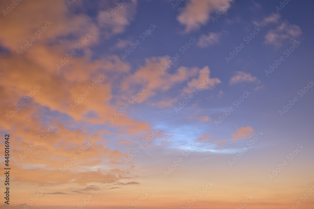Obraz premium Beautiful wide angle view of very rare noctilucent clouds and common clouds seen in Dublin, Ireland on July 12, 2021 a half of hour before midnight. Details of NLC. Night shining clouds