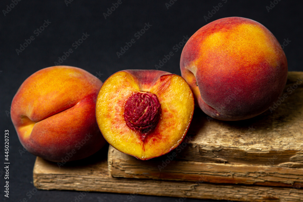 Peaches on a black background. Peach cut in half. Healthy diet. Peaches on a black background. Peach cut in half. Healthy diet.