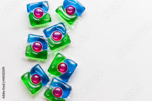 washing pods on white background, close up, abstract color background.liquid detergent,capsules with colored gel.3 in 1 laundry detergent pod. Economic and environment friendly for clothes washing