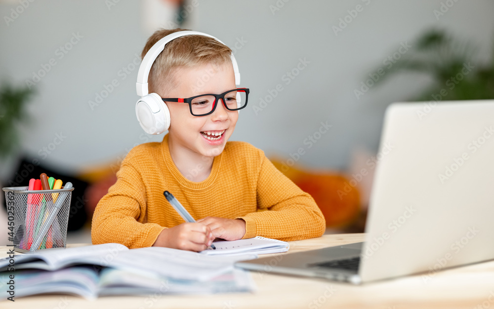 Cheerful boy during online lesson at home Cheerful boy during online lesson at home