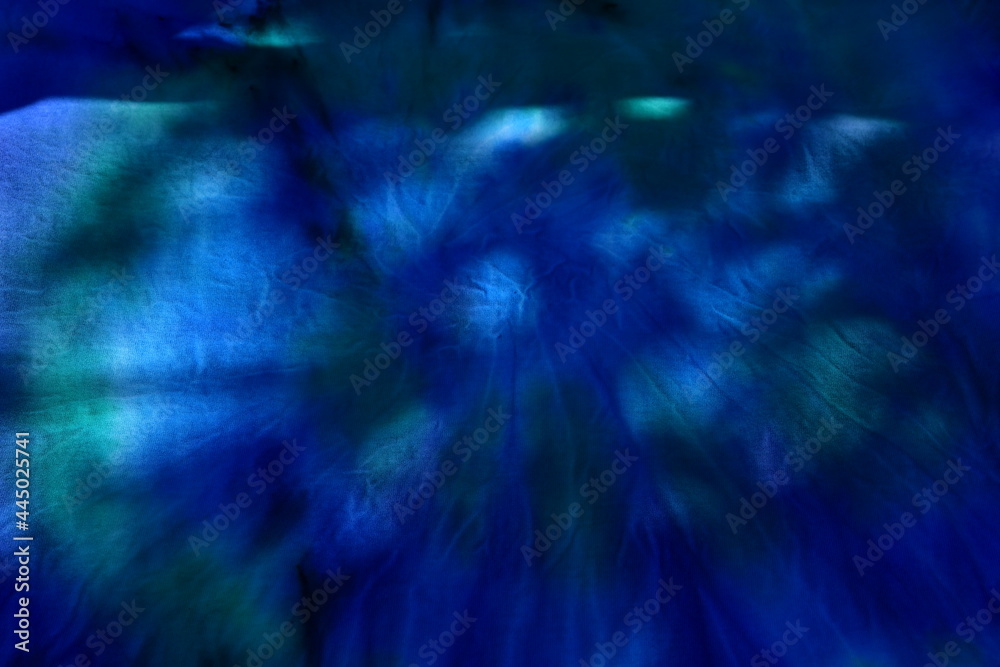Fototapeta premium Abstract painted background. Multi-colored pattern in the shibori technique on a thin knitted fabric. Multi-color texture. batik.Textile shibori