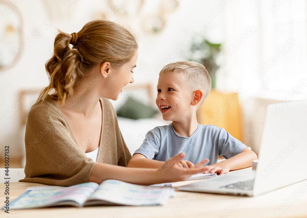 Happy mother supporting son during online studies Happy mother supporting son during online studies