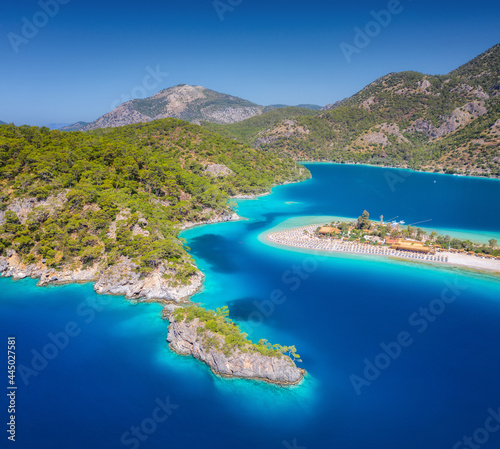 Aerial view of sea bay, rock, sandy beach, trees, mountain at sunny day in summer. Blue lagoon in Oludeniz, Turkey. Tropical landscape with island, white sandy bank, blue water. Top view. Nature