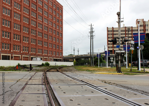 Railway rails in the industrial part of the city. The railway crosses the carriageway of the road.