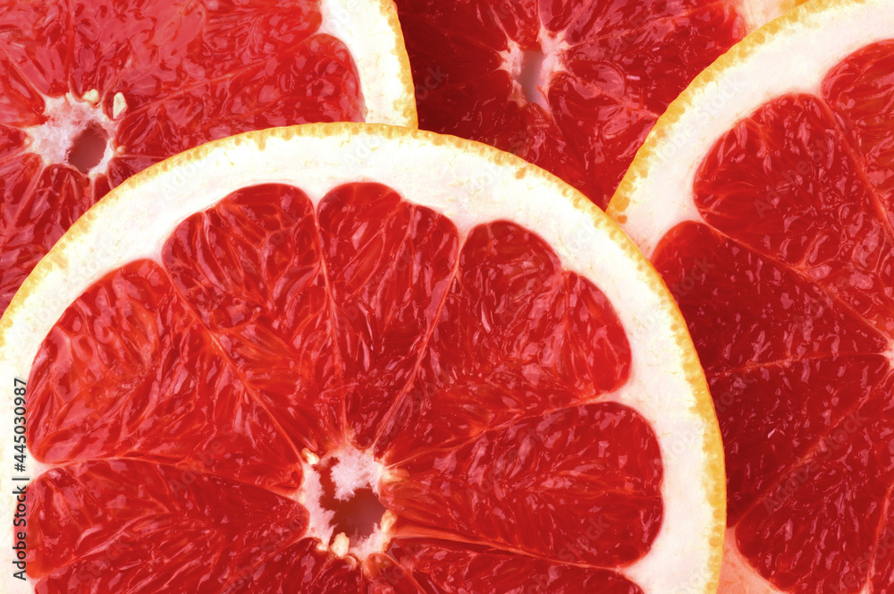 Background from round juicy red grapefruit slices. Fresh fruits. Background from round juicy red grapefruit slices. Fresh fruits.