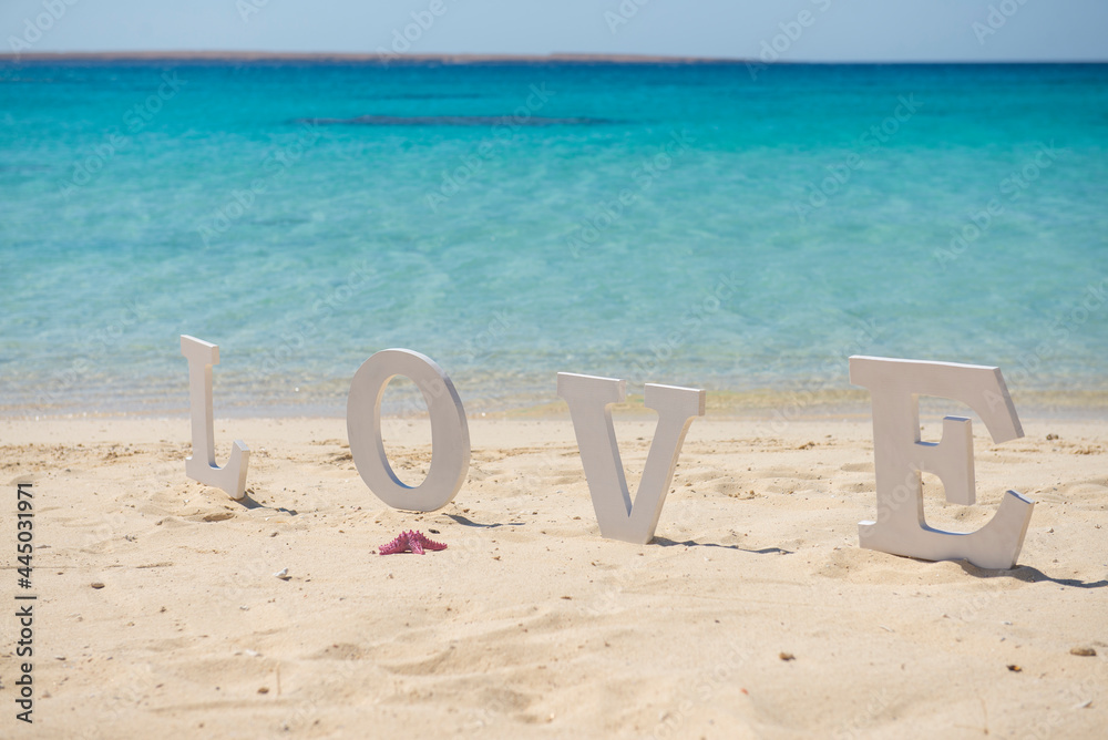 Romantic love sign on a tropical beach paradise Romantic love sign on a tropical beach paradise