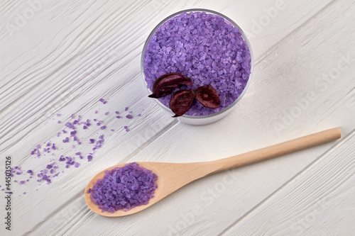 Wooden spoon with pile of purple salt for spa traetment. photo