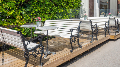 Photography Rows of white wooden benches and tables
