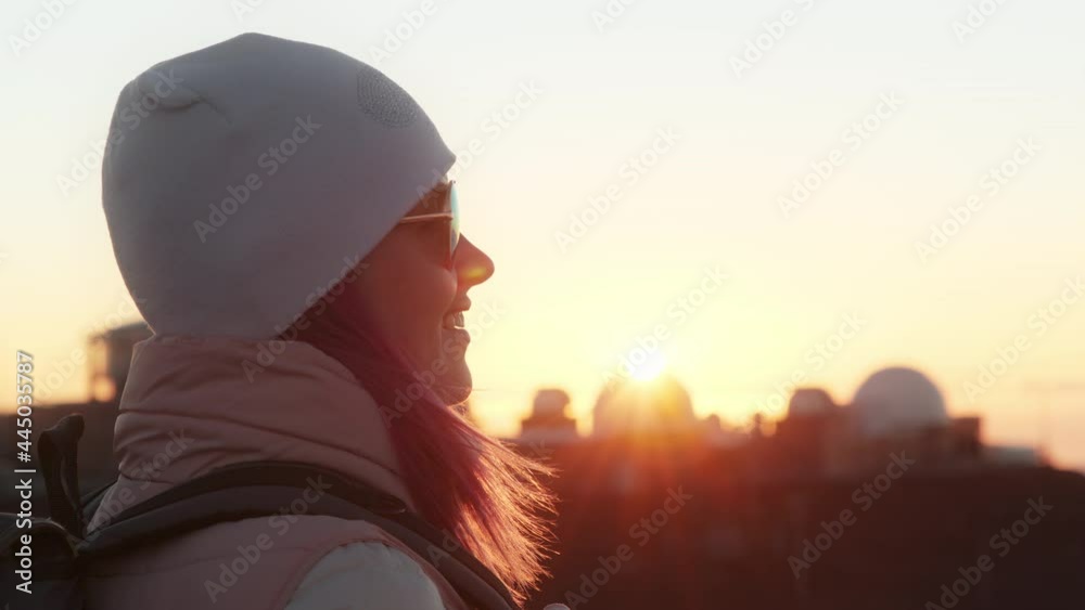 Happy smiling woman looking golden sunset over observatory on mountain summit. Happy smiling woman looking golden sunset over observatory on mountain summit.