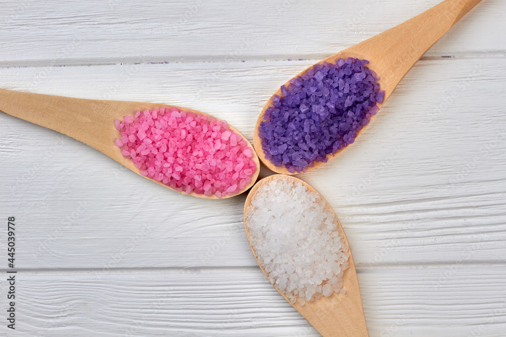 Three wooden spoons with colored salt of different color. Three wooden spoons with colored salt of different color.