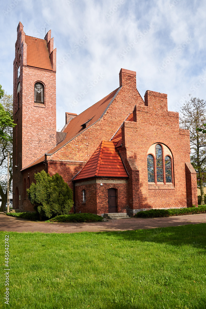Rural Catholic church with a red brick bell tower