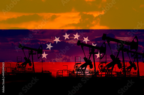 The Venezuelan oil industry. The flag of Venezuela and oil wells on the background of a red sunset -3D illustration
