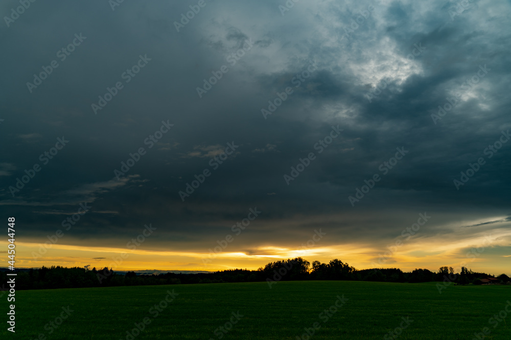 sunset over field, dark clouds, cloud cover, thunderstorm