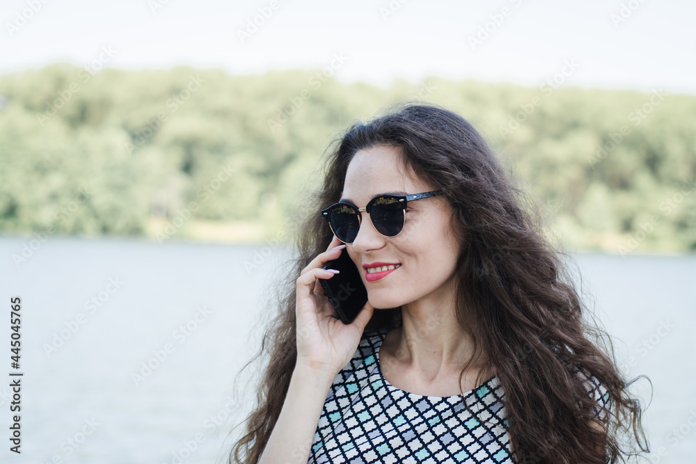 A beautiful Russian girl walks in the city park A beautiful Russian girl walks in the city park