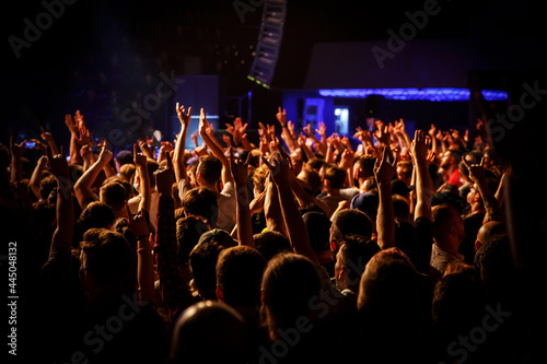 People at a public event. Crowd with raised hands at a concert.