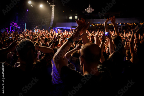 People at a public event. Crowd with raised hands at a concert.