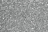 Grunge texture of a wall made of small stones. Monochrome background of fine gravel with spots, noise and grain. Overlay template. Vector illustration