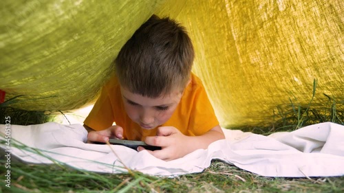 Gameplay. Addicted to phone child smartphone game play. Dependence child face expression of thought game playing phone mobile addiction. Kid emotion faces close up child playing video games addiction