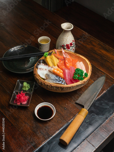 Chirashi Sushi on the wooden table with a Japannese sushi knife.