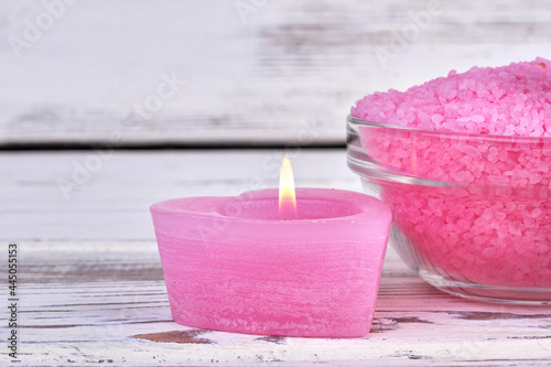 Beautiful spa setting with burning pink candle and salt.