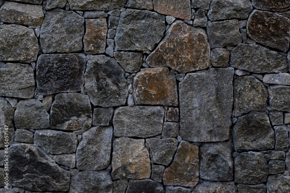 closeup detailed gray-brown stone wall texture background closeup detailed gray-brown stone wall texture background