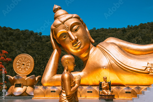 Wat Khao Sung Chaem Fa temple with giant snake and reclining gold buddha  in Kanchanaburi  Thailand