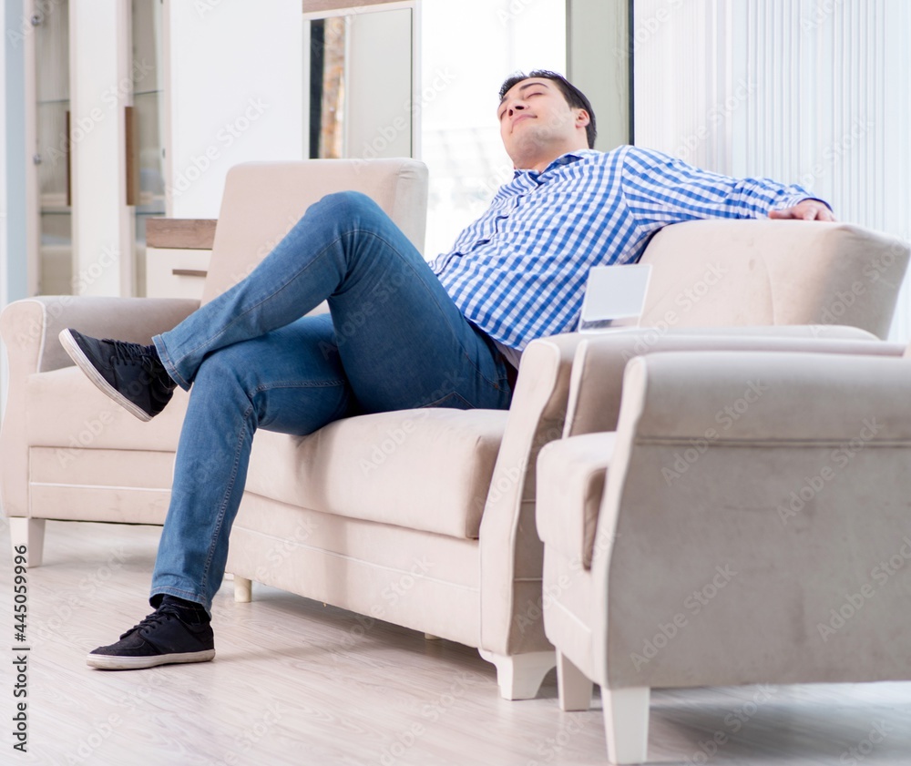 Young man shopping in furniture store Young man shopping in furniture store
