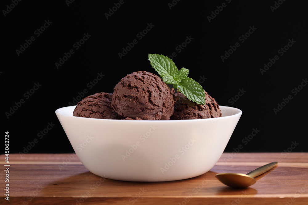 chocolate ice cream in white bowl on cutting board chocolate ice cream in white bowl on cutting board