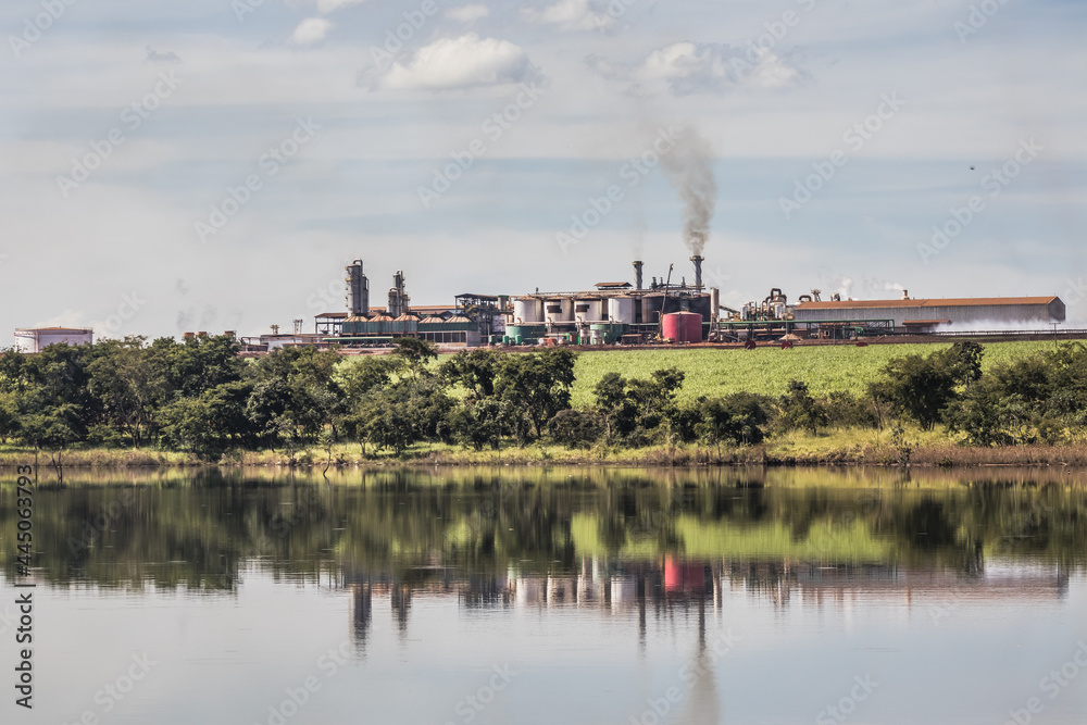Sugarcane processing plant in operation, with dam in the foreground in the interior of Goias, Brazil
