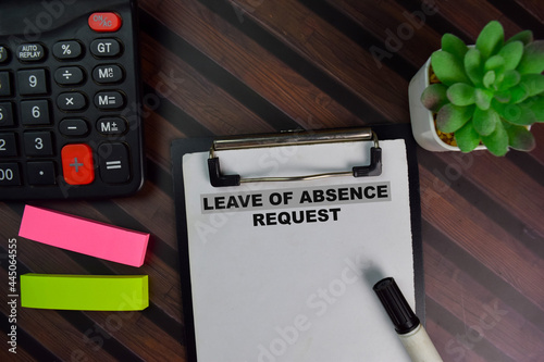 Фотография Leave of Absence Request write on a paperwork isolated on Wooden Table