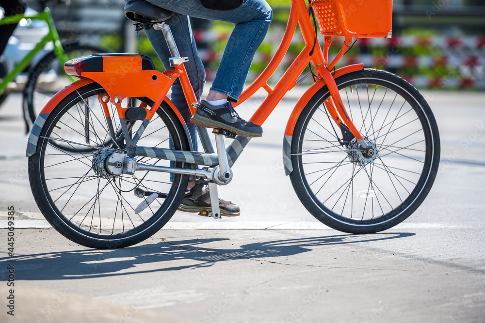 Obraz premium Cyclists ride comfortable rented bicycles along the city street