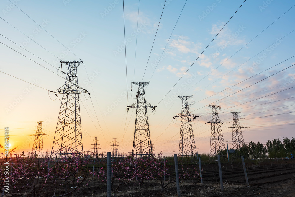 In the evening, the silhouette of high voltage towers