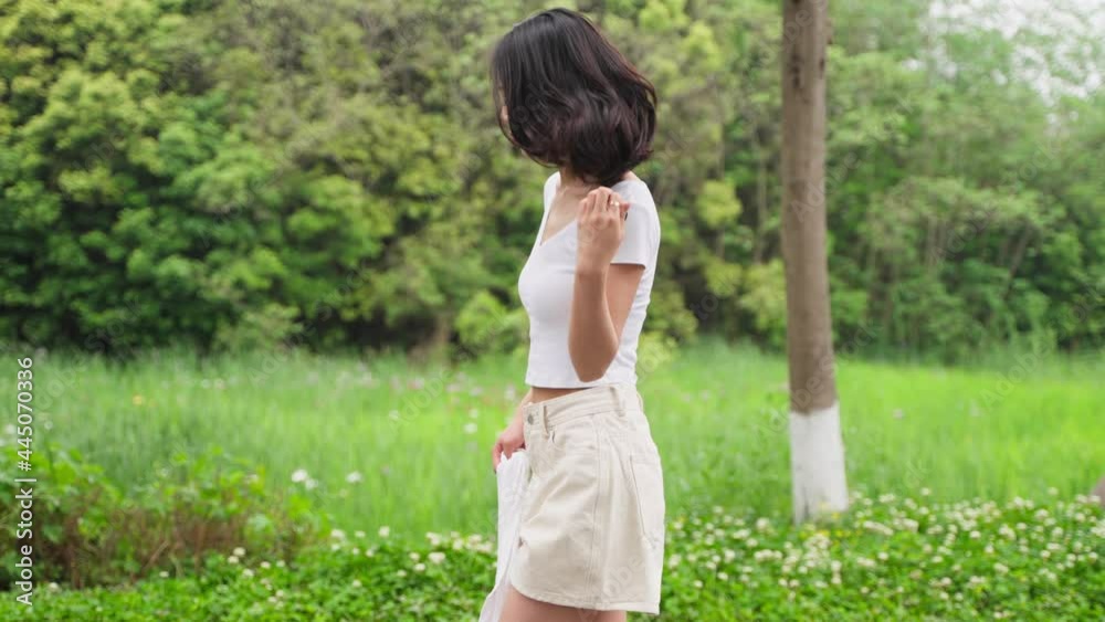 pretty young asian woman walking in the countryside at summer day 4k slow motion side view lovely charming girl relax enjoy the nature lovely day looking at camera smile pretty young asian woman walking in the countryside at summer day 4k slow motion side view lovely charming girl relax enjoy the nature lovely day looking at camera smile