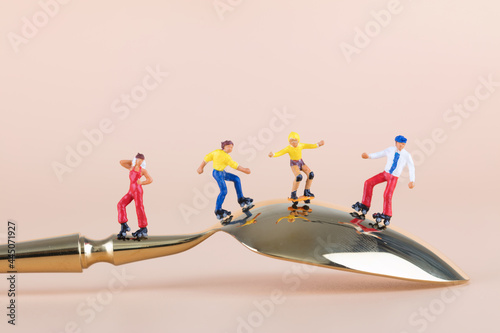 A team of rollerblading exercisers exercising on a spoon photo