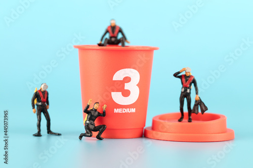 A cup of coffee and frogman diver