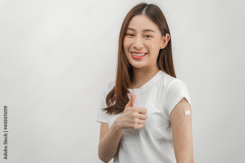 Portrait of pretty, beautiful asian young, teenage attractive after getting, receive anti virus vaccine covid-19. Showing arm on white bandage isolated on white background, copy space. Portrait of pretty, beautiful asian young, teenage attractive after getting, receive anti virus vaccine covid-19. Showing arm on white bandage isolated on white background, copy space.