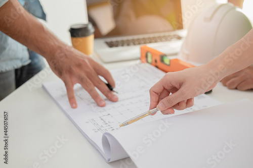 Group business, Team of young colleague, contractor or engineer brainstorming, discussing plan, project on blueprint ,paperwork at workplace, office. Engineering, construction working people concept.