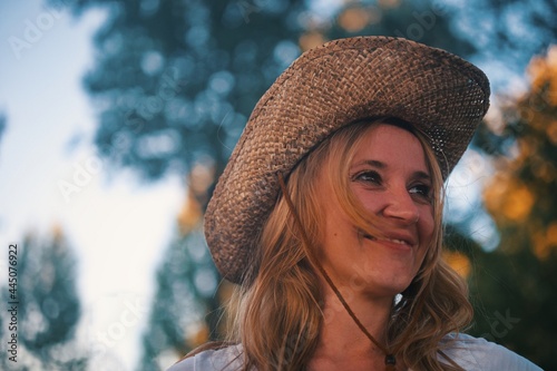 Beautiful mature woman with straw hat smiling