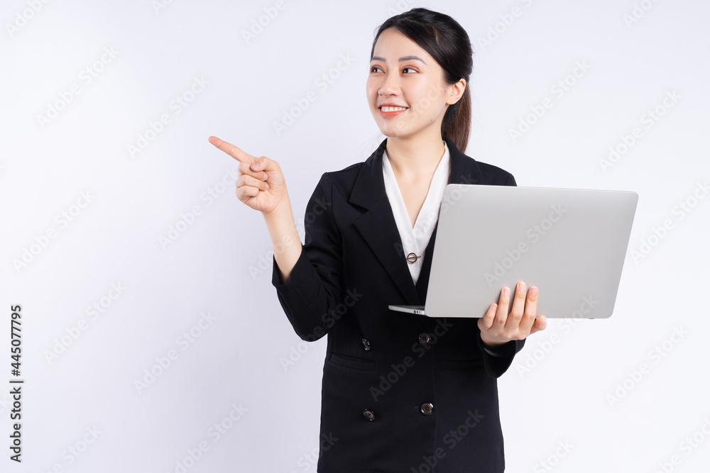 Young Asian businesswoman using laptop on white background Young Asian businesswoman using laptop on white background