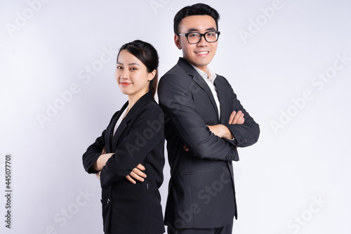 Asian businessman and businesswoman posing on white background