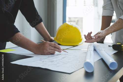 Team of engineers and architects, working team, meeting, discussing construction and drawing construction plans, printing, writing on-site construction sites. Home design concept