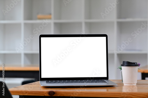 Fototapeta Naklejka Na Ścianę i Meble -  Mock up laptop and cup of coffee on wooden desk in office.