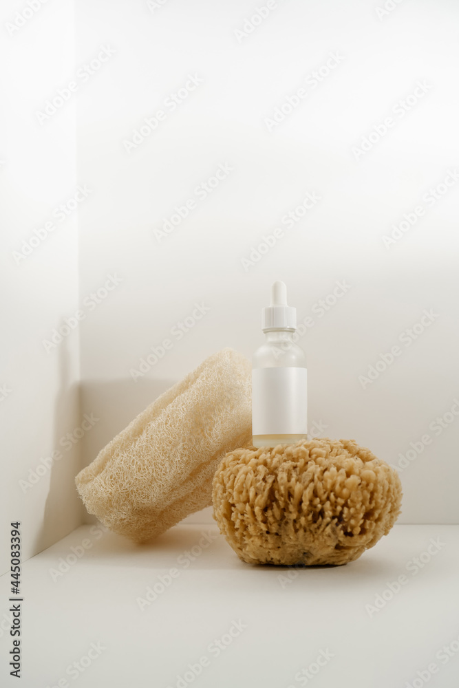 Serum and natural sponges on a light background. Serum and natural sponges on a light background.