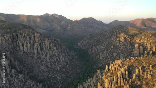 Aerial view of mountains in Arizona during midday. Rock formations can be seen in the Chiricahua National Monument as well as blue skies.