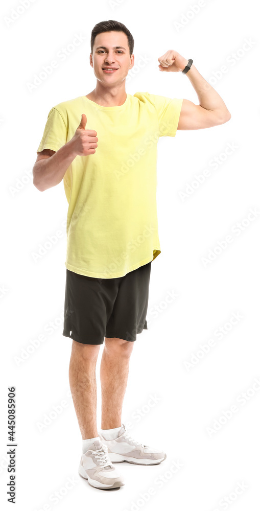 Sporty male coach showing thumb-up on white background Sporty male coach showing thumb-up on white background