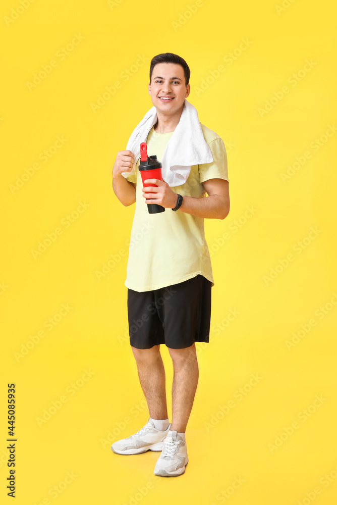 Sporty male coach with bottle of water on color background Sporty male coach with bottle of water on color background