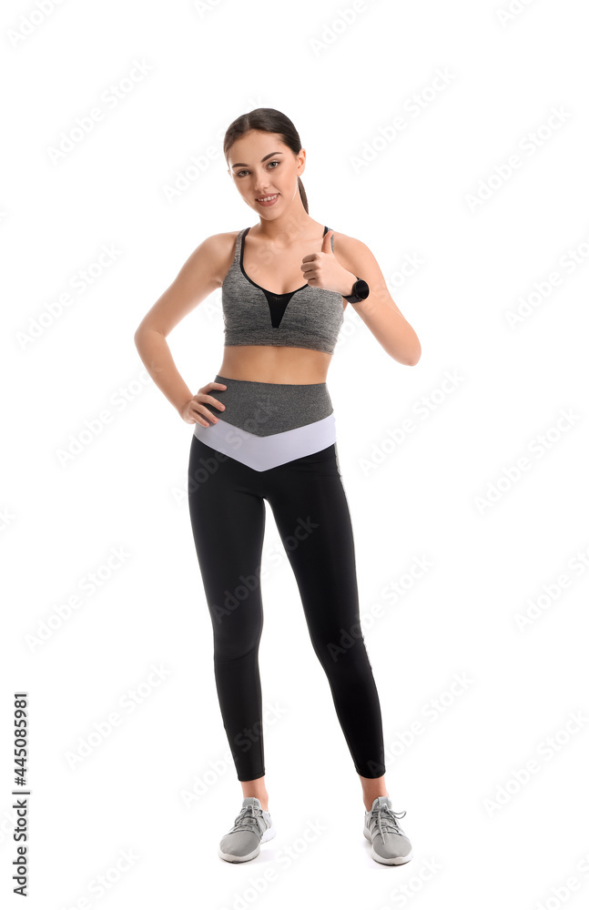 Sporty female coach showing thumb-up on white background Sporty female coach showing thumb-up on white background