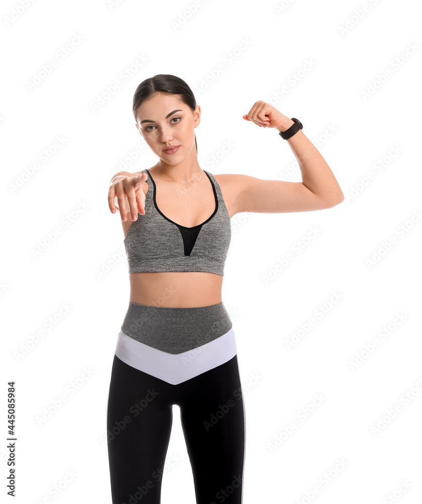Sporty female coach pointing at viewer on white background Sporty female coach pointing at viewer on white background